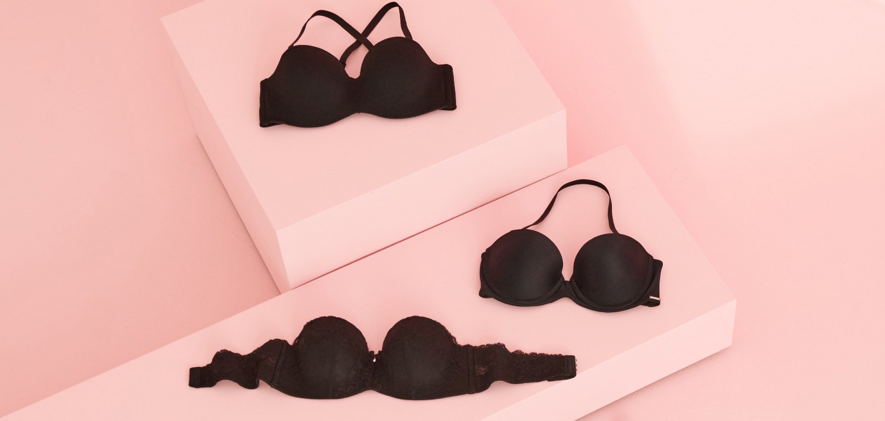 3 black bras displayed on a pink background