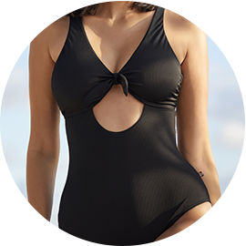 Model wearing a black one-piece swimsuit