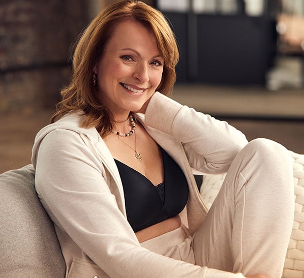 Image of woman wearing loungewear and black bra