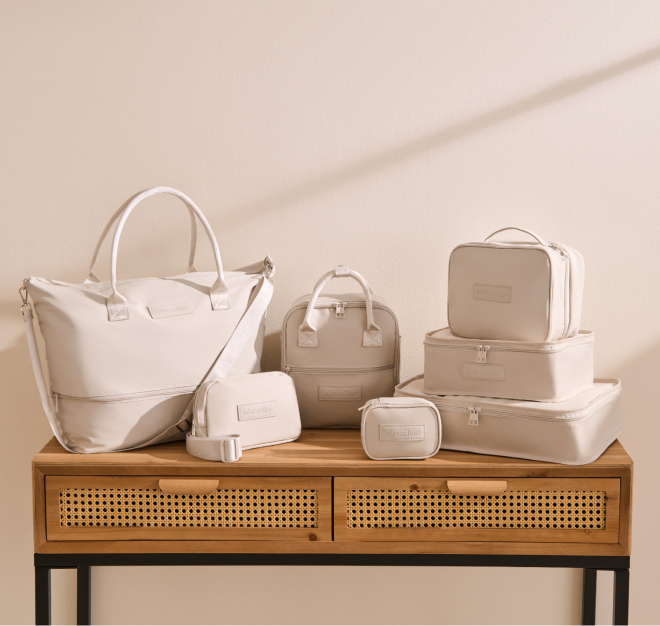 A collection of travel accessories in beige.