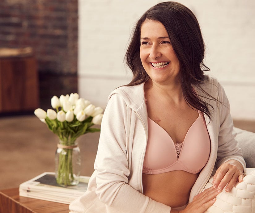 Image of woman wearing loungewear and pink bra